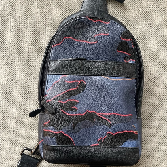 coach charles backpack camo Charter with Print Club de Mode Signature coated canvas and smooth calf leather Two separate main compartments with zip closures Inside zip cell phone and multifunction pockets Fabric lining Top handle with 3 1/4 drop Outside zip pocket Adjustable shoulder straps 12 1/2 (L) x 16 3/4 (H) x 6 (W) Style No. COACH Charles Moto Camo F31299